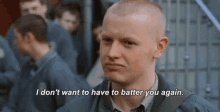 a bald man is standing in front of a group of men and saying `` i don 't want to have to batter you again .