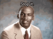 a man in a suit and tie is saying stop it .