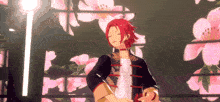 a man with red hair is standing in front of pink flowers
