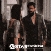 a man and a woman are standing next to each other with a star tamil chat logo in the background