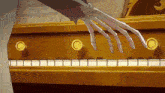 a skeleton hand is playing a piano with a sheet music in the background
