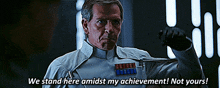 a man in a star wars uniform says " we stand here amidst my achievement "