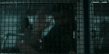 a man is behind bars in a dark room with the words pranat varma on the bottom