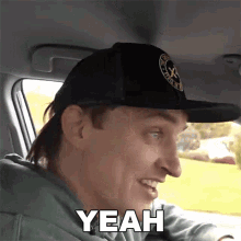 a man wearing a hat says " yeah " in a car