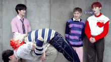a group of young men are standing in front of a wall and one of them is wearing a shirt that says " i love you "