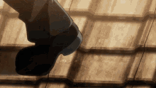 a person 's foot is standing on a wooden surface