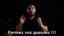 a man making a gesture with the words fermez vos gueules written below him