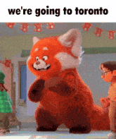 a stuffed animal with the words " we 're going to toronto " on the bottom