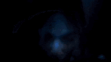 a close up of a woman 's face with a glowing blue background