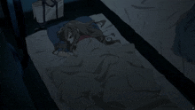 a girl is laying on a bed with a blanket on