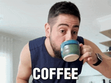 a man is drinking a cup of coffee with the word coffee written on his shirt