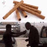 a man is holding a gun next to a pile of cinnamon sticks ..