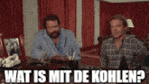 two men are sitting at a desk and one of them is asking what is mit de kohlen ?
