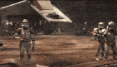 a group of storm trooper soldiers are standing in front of a plane