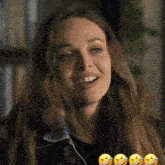 a close up of a woman laughing with her tongue out .