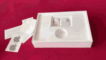 a white box with an apple logo on the side of it