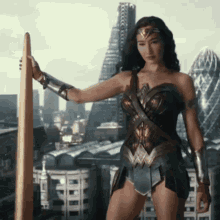 a woman in a wonder woman costume is holding a sword