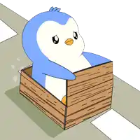 a penguin is sitting in a wooden box
