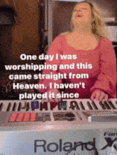 a woman singing while playing a keyboard that says roland on it