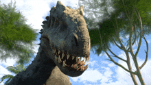 a close up of a dinosaur with its mouth open and trees in the background