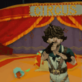 a man in overalls stands in front of a sign that says circus