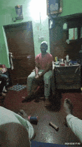 a man sits in a chair with a sticker on his pants that says ' nb ' on it