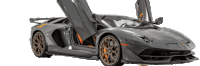 a grey lamborghini aventador with its doors open