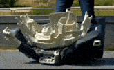 a person is standing next to a model of a car 's engine