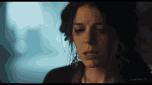 a close up of a woman 's face with a tear coming out of her eye and the words lostfilm.tv below it