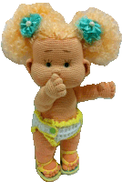 a crocheted doll has a flower in her hair and a diaper on