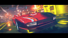 a red sports car is driving down a city street