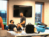 two men are sitting on a table and one of them says yeah