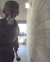a person wearing a gas mask and a helmet is standing in a hallway