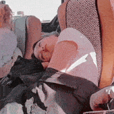 a person is sleeping in a chair with a pattern on the seat