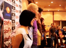 a group of people are standing in front of a wall that says rbd
