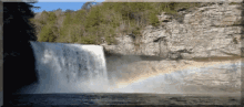 a waterfall with a rainbow in the middle