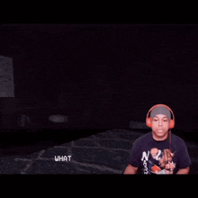 a man wearing headphones is playing a video game with a press e to interact button