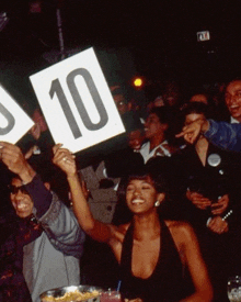 a group of people are holding up a sign that says 10