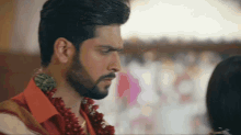 a man with a beard is looking at a woman