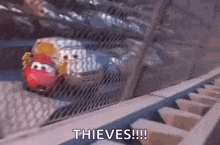 a car is driving down a roller coaster with the words `` thieves !!! '' written on it .
