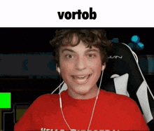 a young man wearing headphones and a red shirt with the word vortob on the bottom