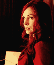 a close up of a woman with red hair