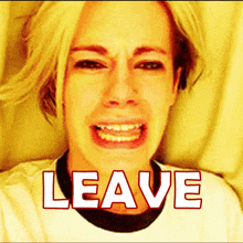 a woman is crying and the word leave is above her face