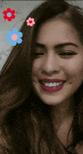 a woman with flowers in her hair is smiling for the camera