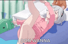 a girl in a pink shirt is laying on a bed with the words i don wanna above her