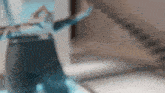 a blurred image of a person with their arms outstretched in a room