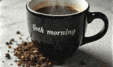 a cup of coffee with the words goth morning on it