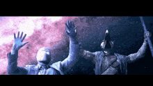 a statue of a man and a statue of a bird with their arms outstretched