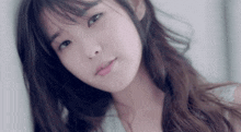 a close up of a woman 's face with long hair and bangs