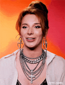 a woman wearing a bun and a necklace with a cross